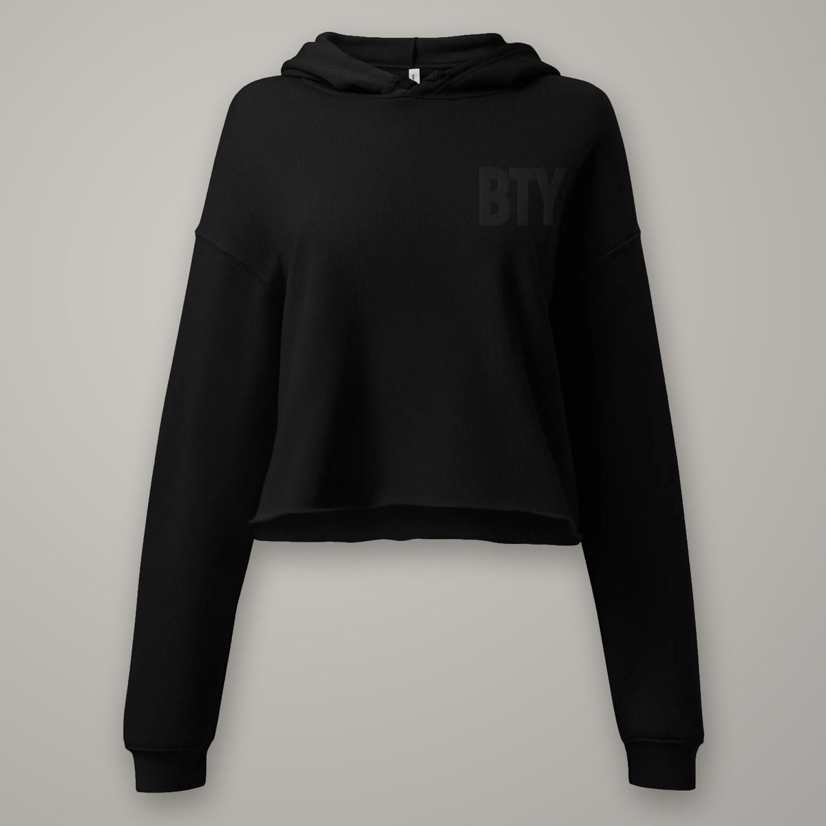 Hoodie Crop Coupe Féminine BTY sur fond studio béton.